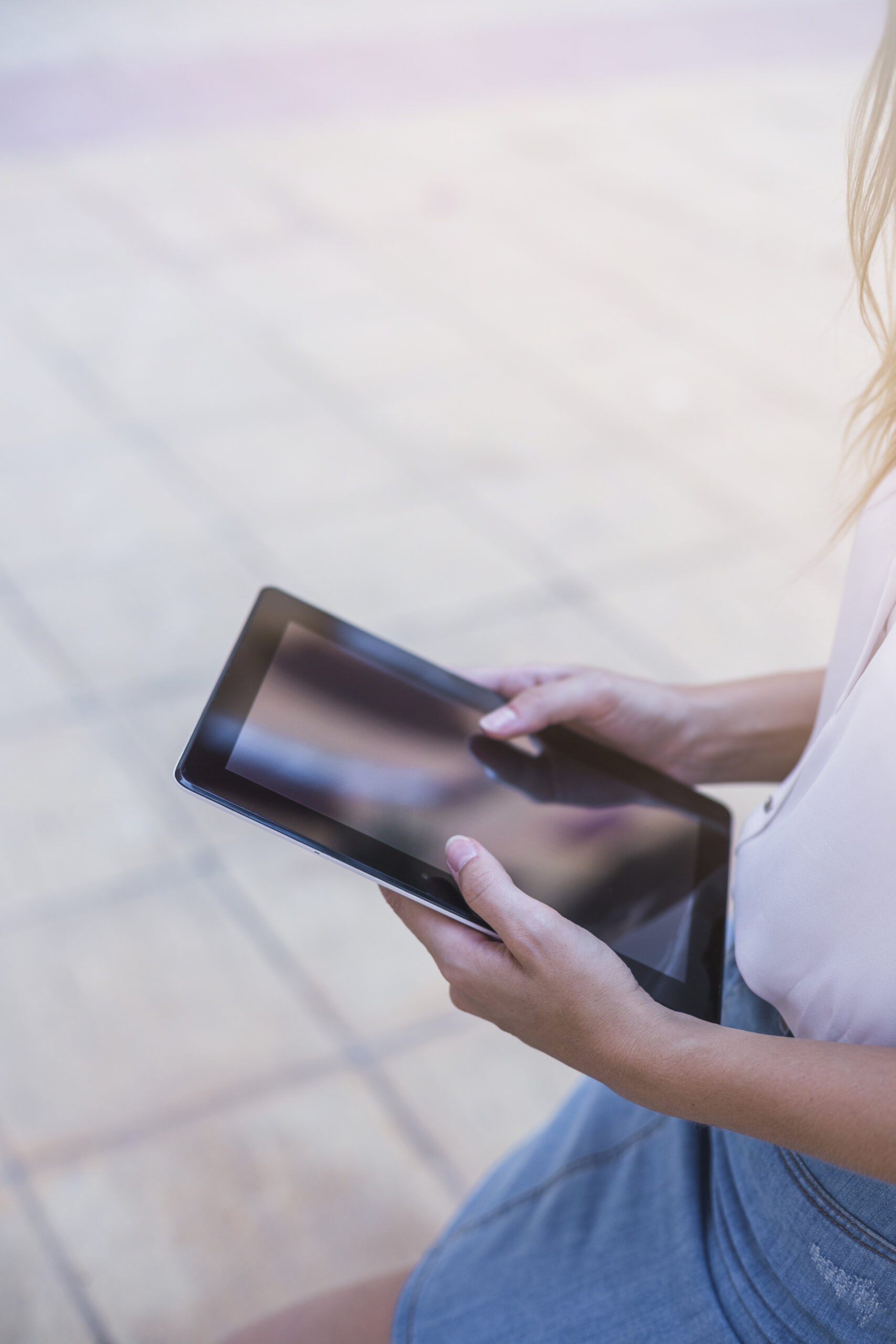 woman-s-hand-using-digital-tablet